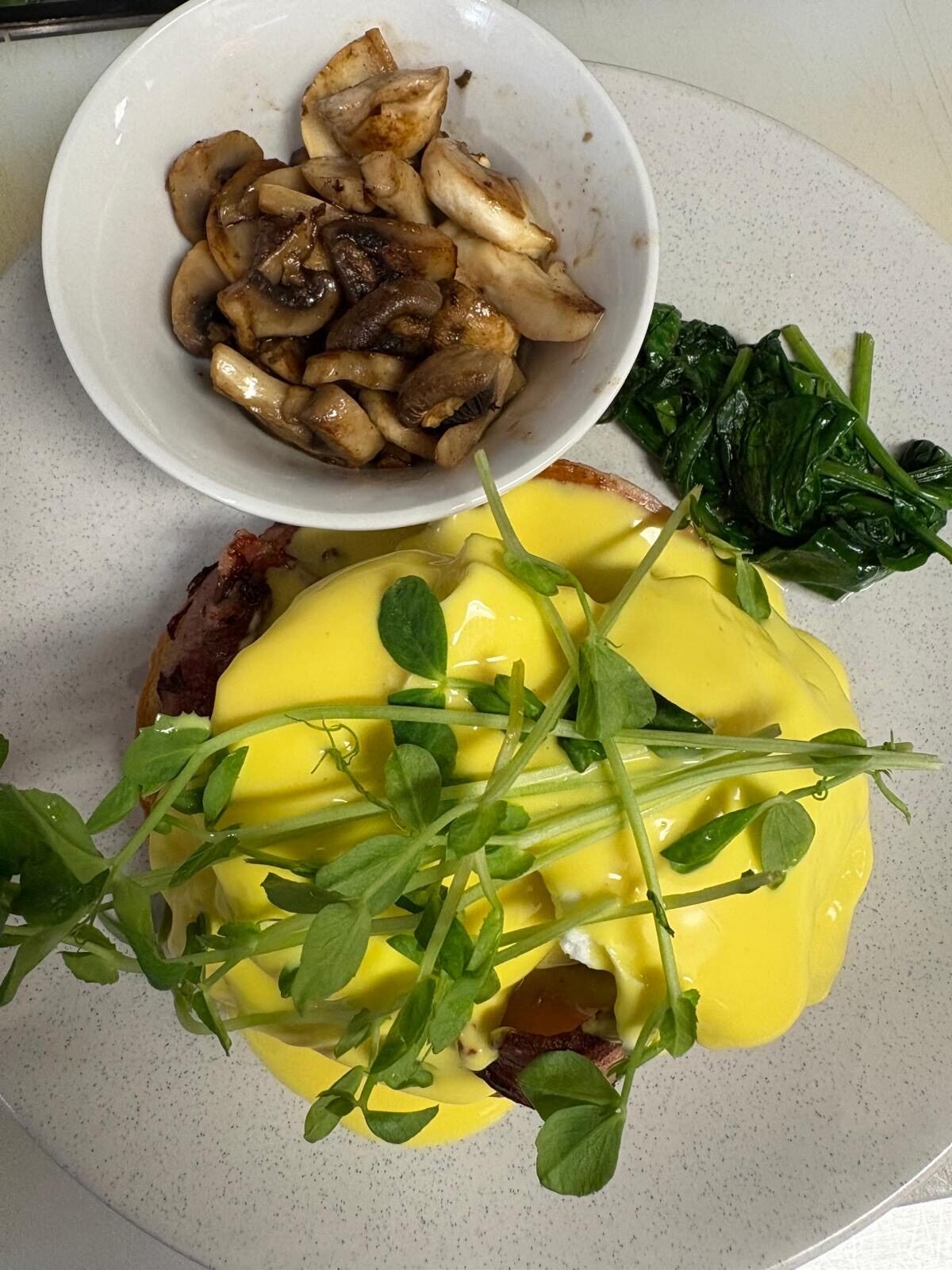 Eggs benedict with side of mushrooms